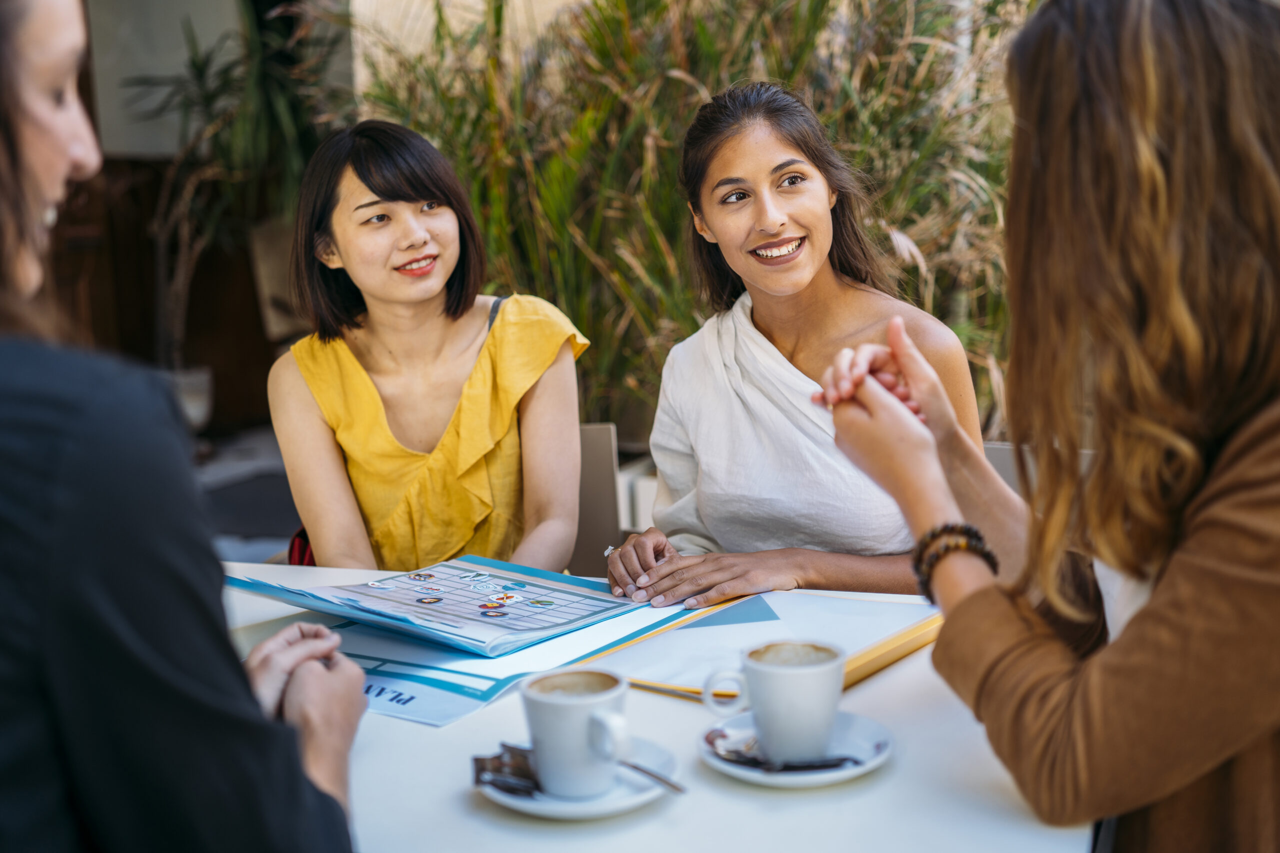 Direct marketing professionals meeting clients over coffee.