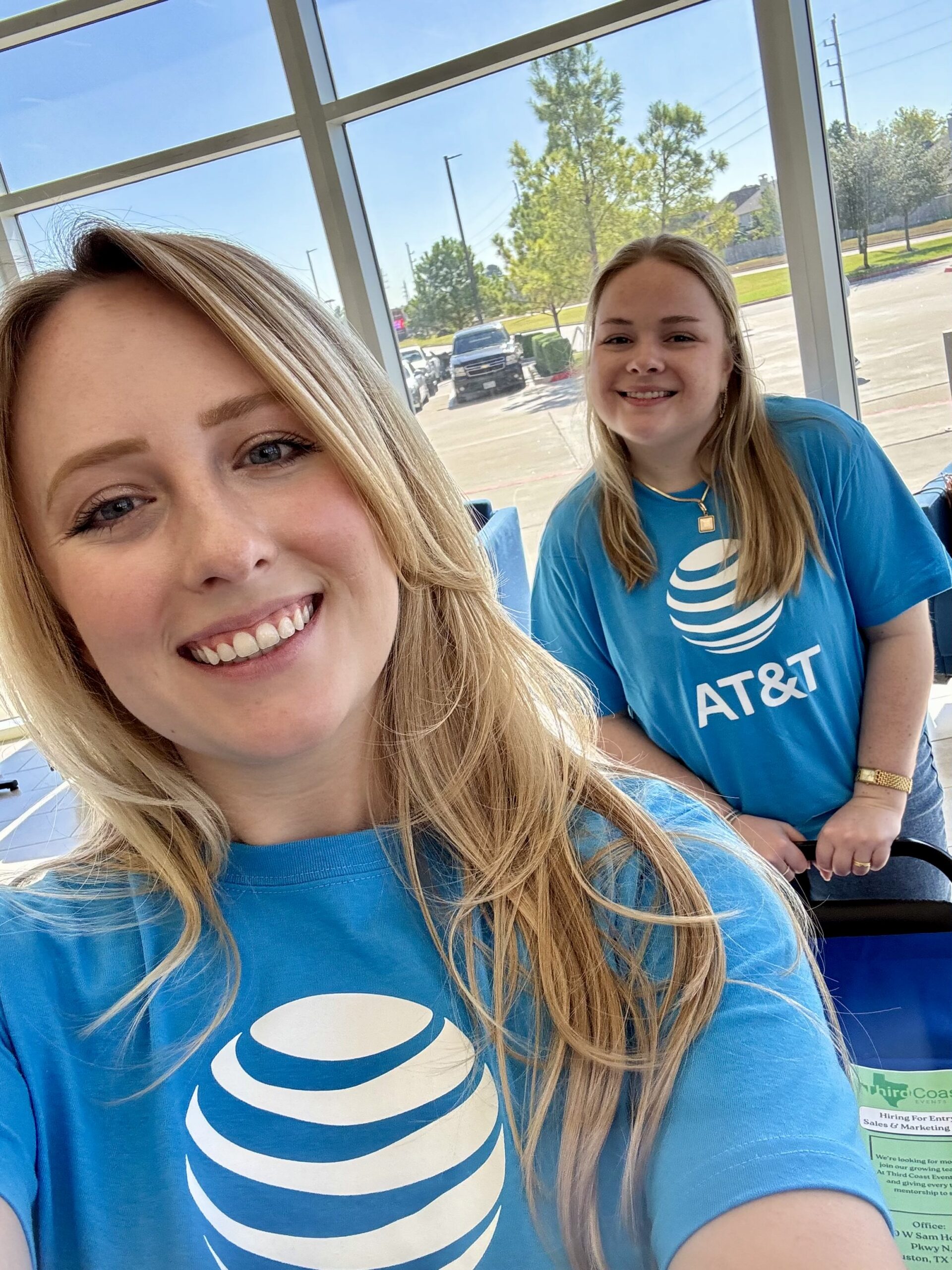 Two team members wearing blue AT&T shirts at a promotional event